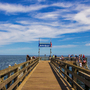 Holzsteg in die Ostsee mit Menschen und blauem Himmel in Boltenhagen.