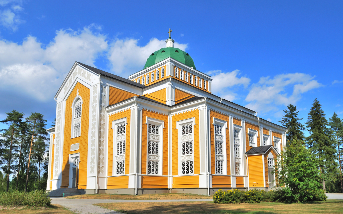 Holzkirche in Kerimäki, Finnland bei sonnigem Wetter mit blauem Himmel im Hintergrund