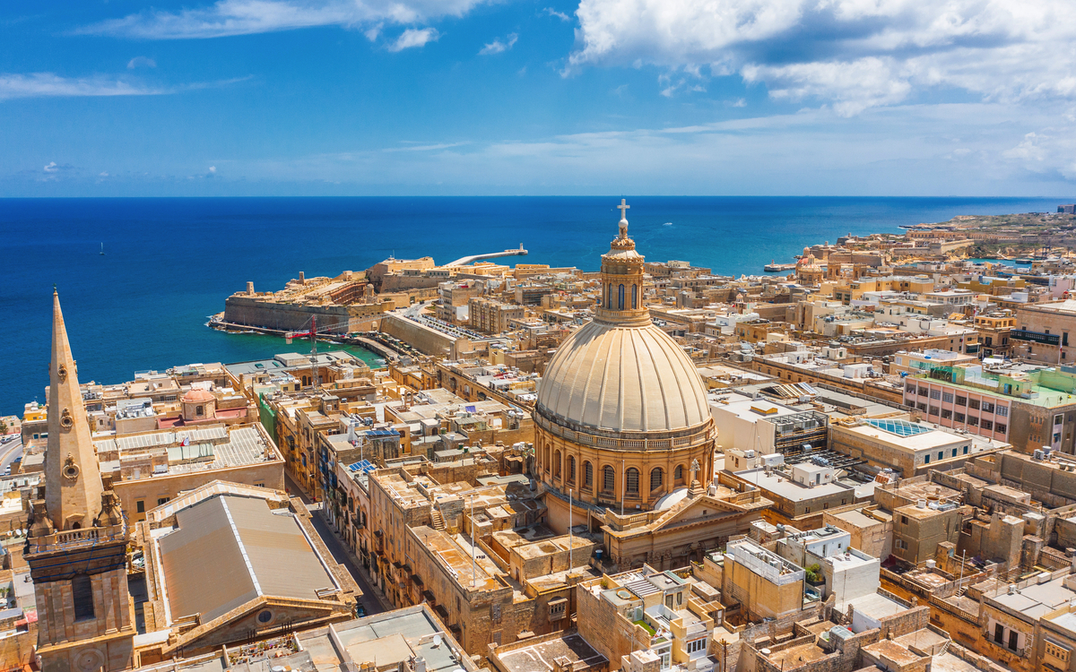 Stadtansicht von Valletta, Malta mit der Kuppel der Karmelitengemeinde und Meer im Hintergrund.