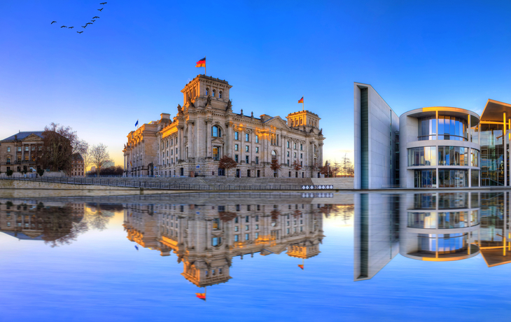 Panoramablick auf das Regierungsviertel in Berlin mit Reichstag, Kanzleramt und der Spree im Winter.