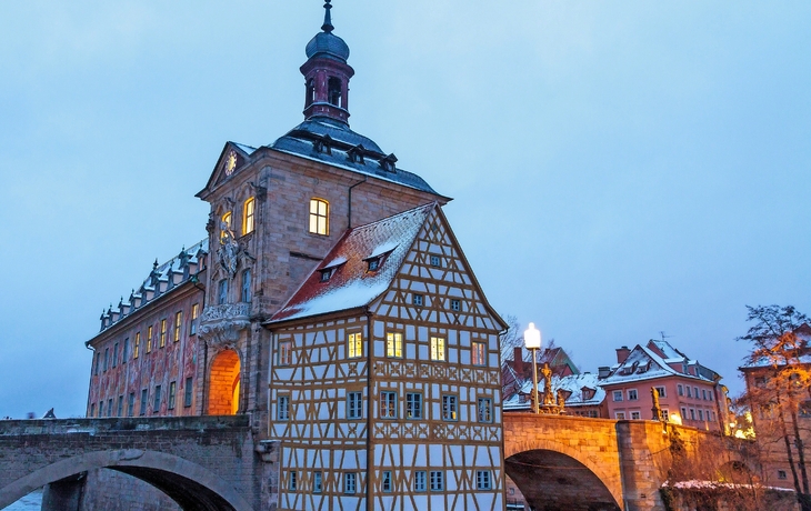 Altes Rathaus Bamberg im Winterdämmerlicht auf einer Brücke.